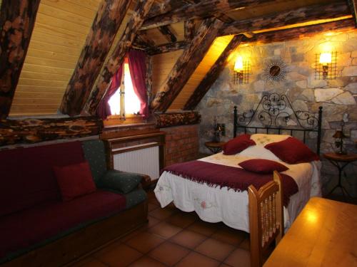 a bedroom with a bed and a couch in a room at Casa Rural Fontamil in Gistaín