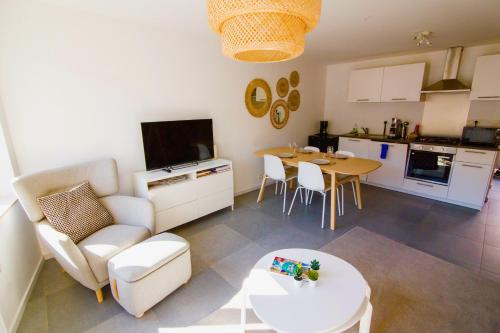 a kitchen and a living room with a table and chairs at Residence Royal Sélys, City-Center - Bike Parking and Outdoor in Liège