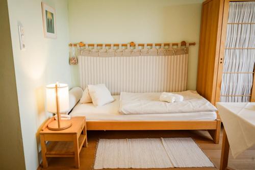 a bedroom with a bed and a table with a lamp at Panoramahotel Wagner - Das Biohotel am Semmering in Semmering