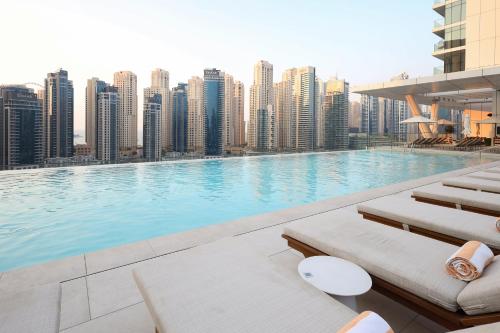 a large swimming pool on top of a city skyline at Vida Dubai Marina & Yacht Club, Hotel and Residences, Luxurious 2BR in Dubai
