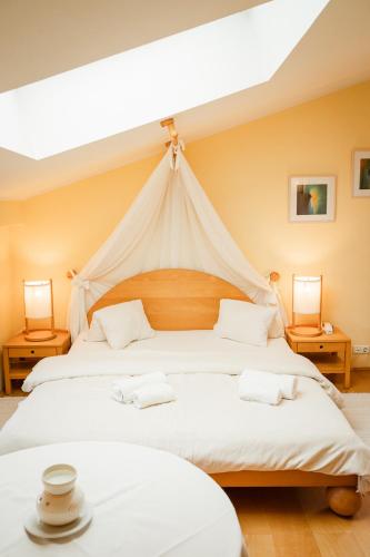 two beds in a room with a tent at Panoramahotel Wagner - Das Biohotel am Semmering in Semmering