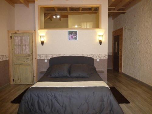 a bedroom with a large bed and a mirror at LES COTEAUX DE VIGNY 