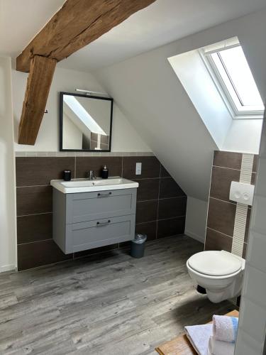a bathroom with a white sink and a toilet at Zur Scheune in Bad Wildungen