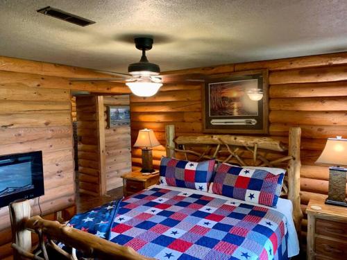 a bedroom with a bed in a room with wooden walls at Buffalo River Lodge (Yellville)- Lower Level in Saint Joe