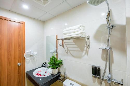 a bathroom with a shower and a sink at Cat Ba Central Sea View - Hoang Ngoc Hotel in Cat Ba