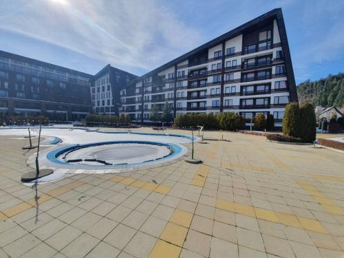 a large building with a large circle in a courtyard at Aspen Valley B304 in Razlog