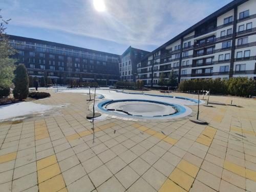 a large building with a large circle in a courtyard at Aspen Valley B304 in Razlog
