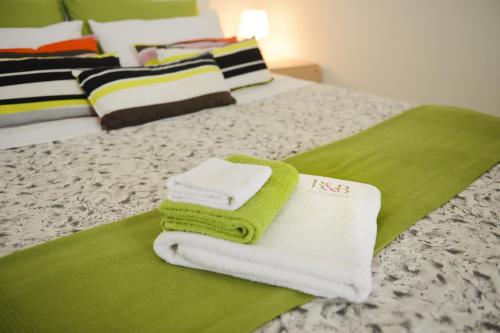 two towels sitting on top of a bed at B&B Affittacamere Del Teatro in Brindisi