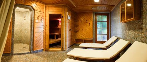 a room with two white chairs in a room at Panoramahotel Wagner - Das Biohotel am Semmering in Semmering