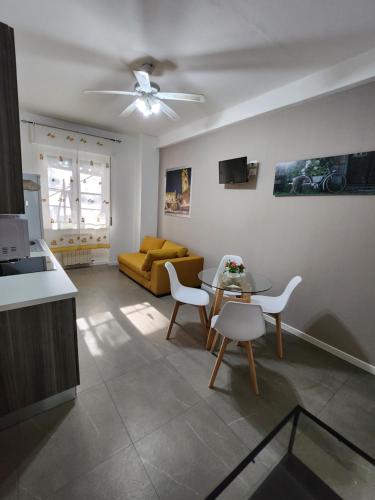 a living room with a couch and a table and chairs at Camere ed Appartamenti in centro a Bergamo in Bergamo