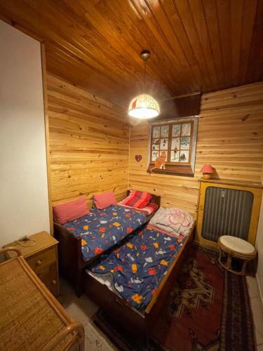 a bedroom with a bed in a wooden cabin at Gréolières La Floconnière in Gréolières