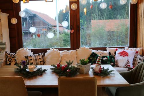 a dining room table with christmas decorations on it at Villa Pribila in Jasenak