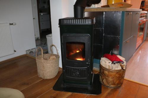 a stove sitting in a living room next to a floor at Villa Pribila in Jasenak