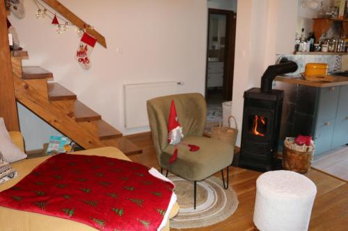 a living room with a chair and a stove at Villa Pribila in Jasenak