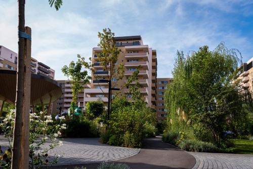 a courtyard with trees and buildings in a city at JAD - Luxury - 3 Room Apartments - Urban Plaza in Braşov