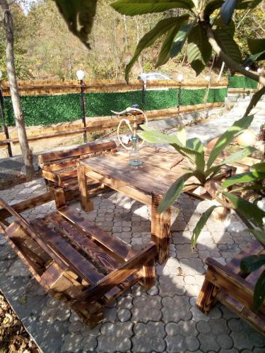 a wooden picnic table with a faucet on it at Cottage "Sunset" in Batumi