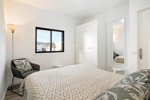 a white bedroom with a bed and a window at Eras Views in Las Eras