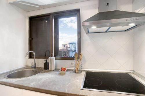 a kitchen counter with a sink and a window at Eras Views in Las Eras