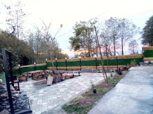 a patio with a fence and a picnic table at Cottage "Sunset" in Batumi