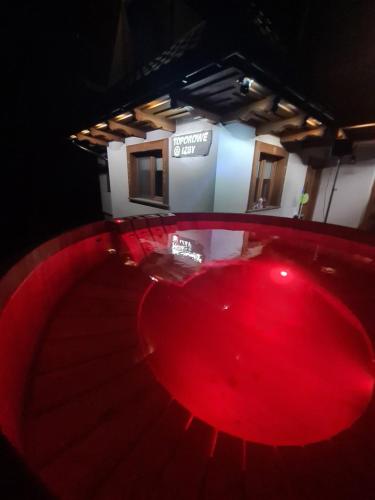 a red table in a room with a building at Toporowe Izby in Groń