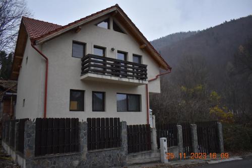 a house with a fence in front of it at Capra cu trei iezi in Sinaia