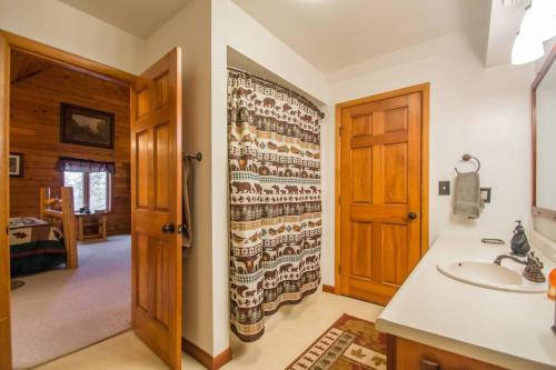 een badkamer met een wastafel en een houten deur bij Buffalo River Lodge St Joe AR in Maumee