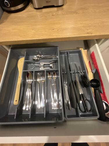 a drawer filled with utensils on a table at Apartment Golden Prague 78 in Vestec