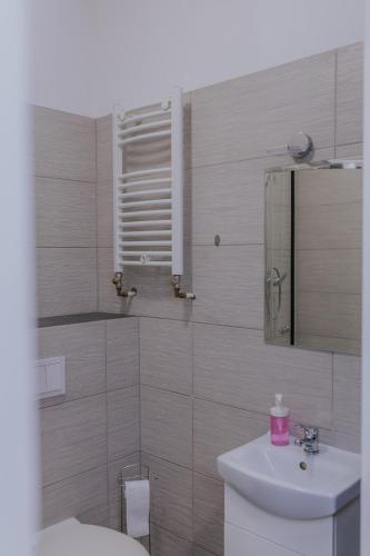 a bathroom with a toilet and a sink at VESTA Apartamenty P23 in Szczecin