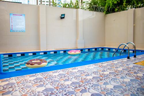 a swimming pool with two donuts in the water at SGH hotel Mathilu Rodadero in Santa Marta