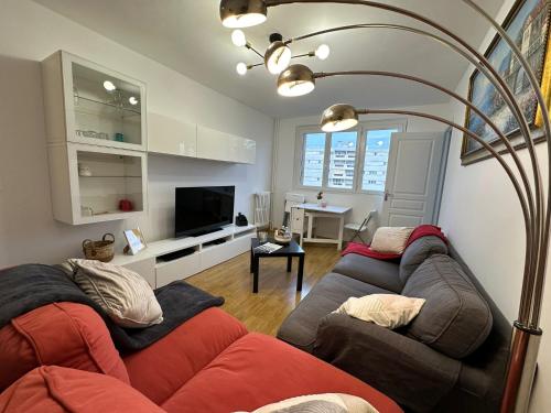 a living room with two couches and a television at 4 Beds Apartment close PARIS center in Vanves