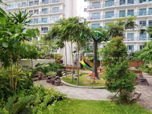 a park with a playground in front of a building at Aveline Suites Elite Rockwell view ACQUA Private Residences near Rockwell Makati in Manila