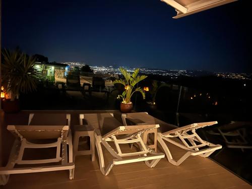 two chairs and a table on a balcony at night at Casa Carolina - This One in Higuerón with Quality and Peace in Mijas