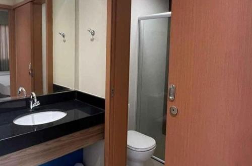 a bathroom with a sink and a toilet and a mirror at São Pedro Thermas Resort in São Pedro