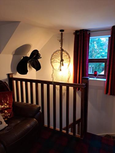 a living room with a couch and a window at Willow's Cottage in Edwinstowe