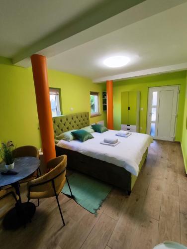 a bedroom with a large bed and a table at Villa Vino & Grad in Zagreb