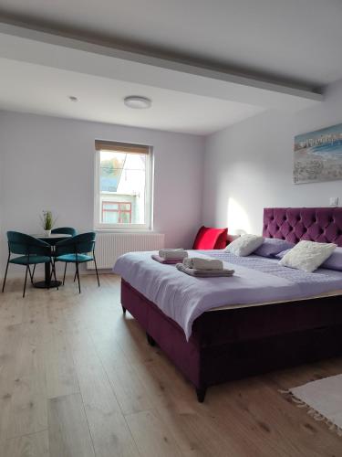 a bedroom with a large bed and a table at Villa Vino & Grad in Zagreb