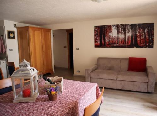 a living room with a table and a couch at Maison Chez Les Roset in Arvier