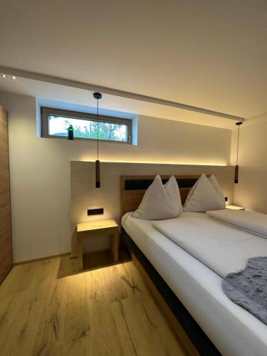 a bedroom with two beds and a window at DAS MANFRED in Sankt Michael im Lungau