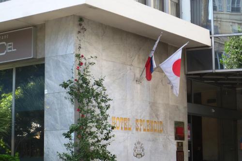 a flag on the side of a building with a flag at Splendid Hotel & Spa Nice in Nice