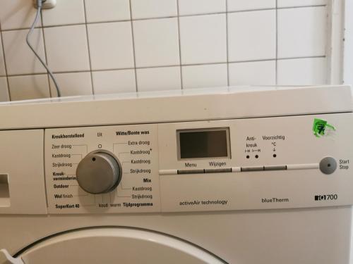 a close up of a washing machine in a bathroom at Olimpijka Lidia Wrzesinska in Więcbork