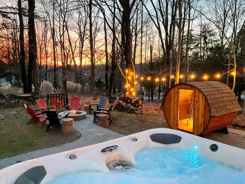 a hot tub in a backyard with a tent at Family Pocono Gem by the lake with private sauna, hot tub, and huge game room in Arrowhead Lake