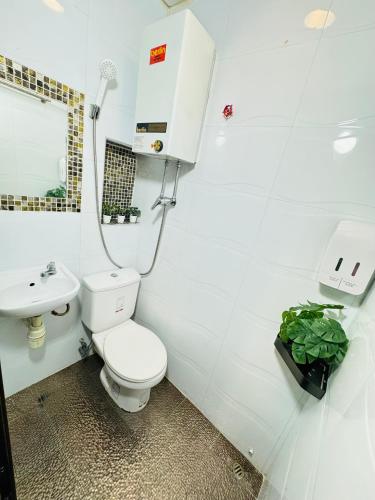 a bathroom with a toilet and a sink at Park Guesthouse in Hong Kong
