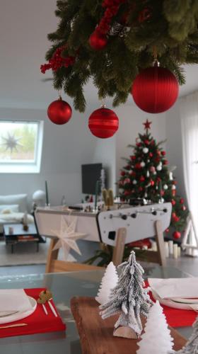 a living room with a christmas tree and a table at Cocoon Bed and Breakfast in Fegersheim