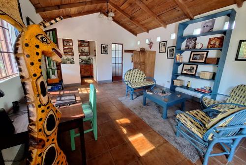 a living room with a giraffe figurine in the middle at Sweet little cottage at Lake La Laguna in San Pedro La Laguna