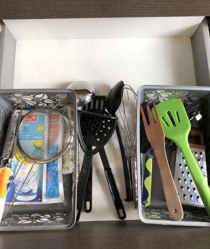 two metal containers with utensils on a shelf at Adrian Home Libra in Ploieşti