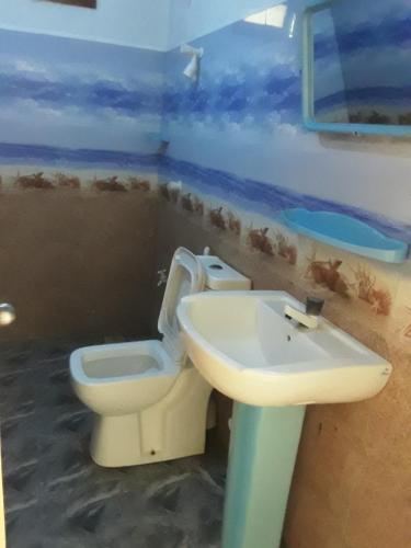 a bathroom with a toilet and a sink at LLT budget room WILPATTU in Nochchiyagama