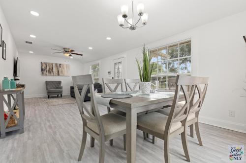 a dining room with a table and chairs at The Good Vibes Only Cottage in Tampa