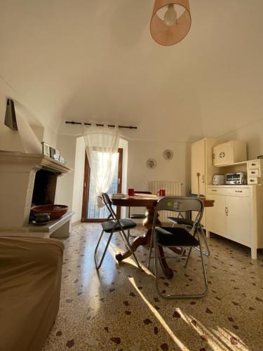 a kitchen with a table and chairs in a room at B&B San Nicola in Pretoro
