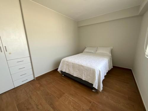 a small bedroom with a bed and a dresser at Apartment 4 Rent - Av San Borja Sur Cdra 4 in Lima