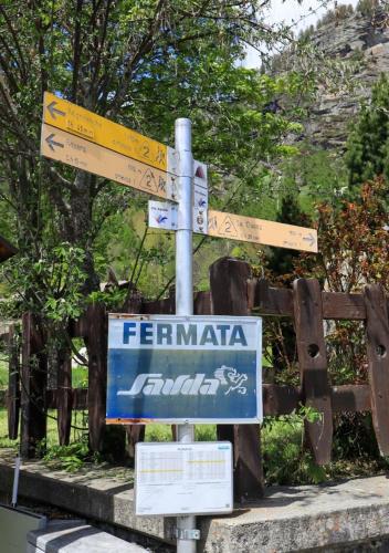 a street sign with several signs on a pole at Maison Chez Les Roset in Arvier